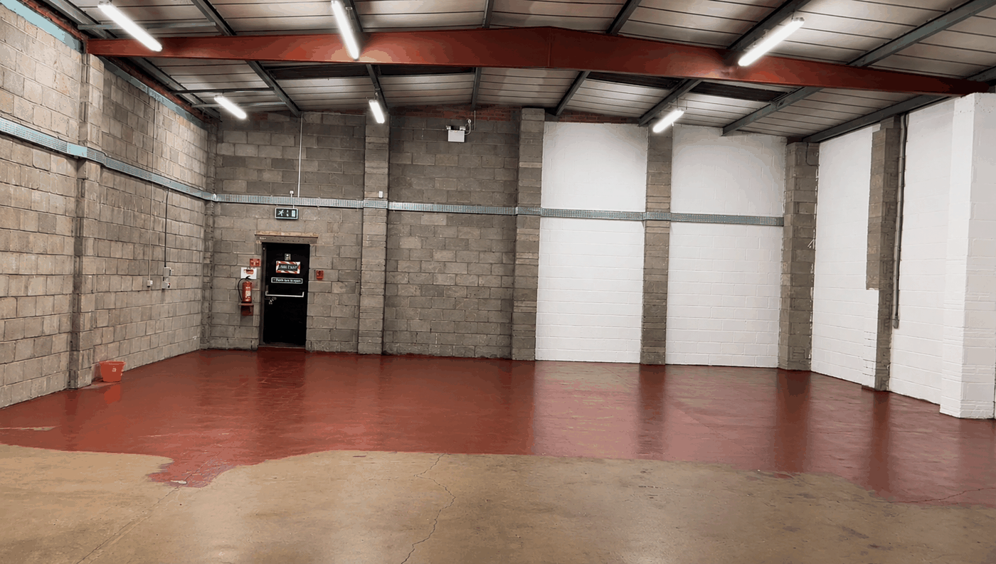 Large industrial unit with freshly painted walls and a red floor coating