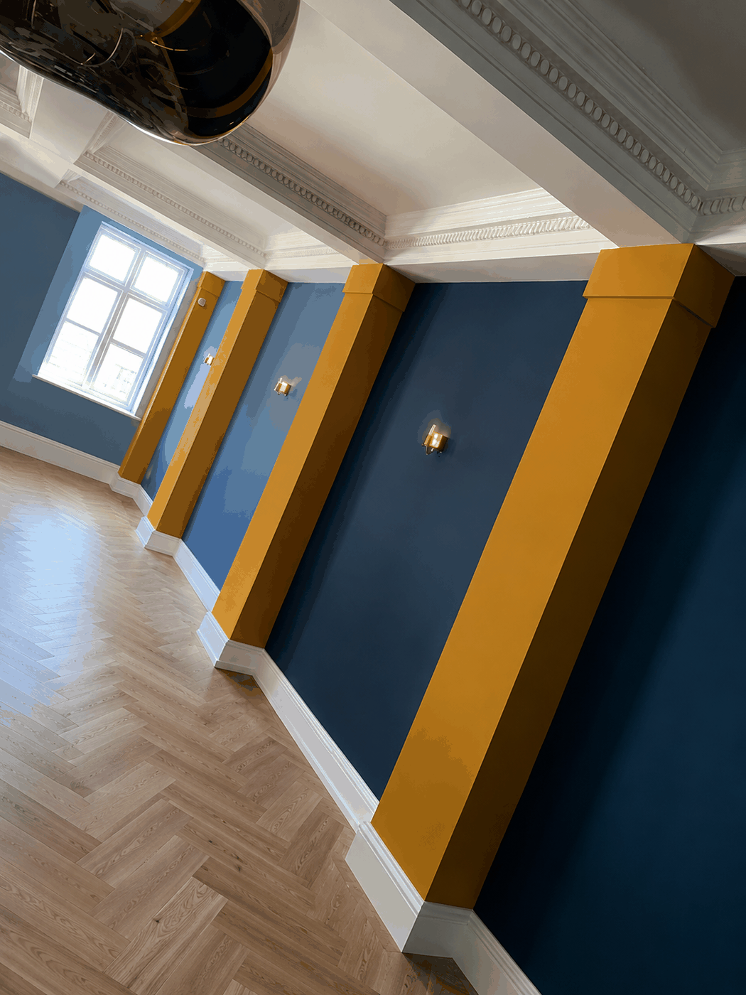 Commercial space with navy walls and yellow painted pillars